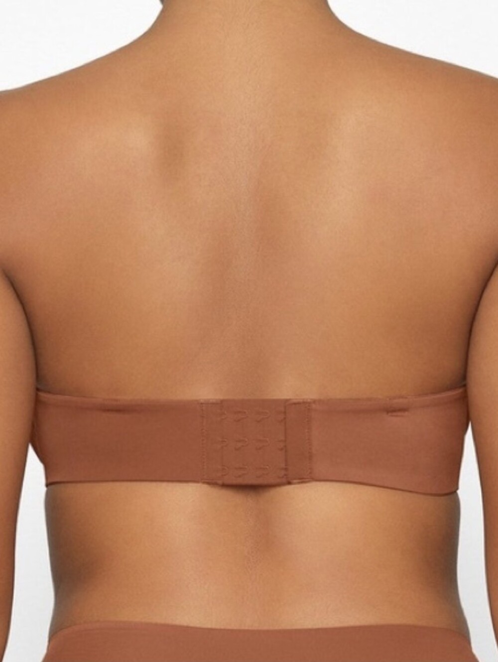 SKIMS Smoothing Intimates Unlined Strapless Bra In Bronze - Picture 2 of 5